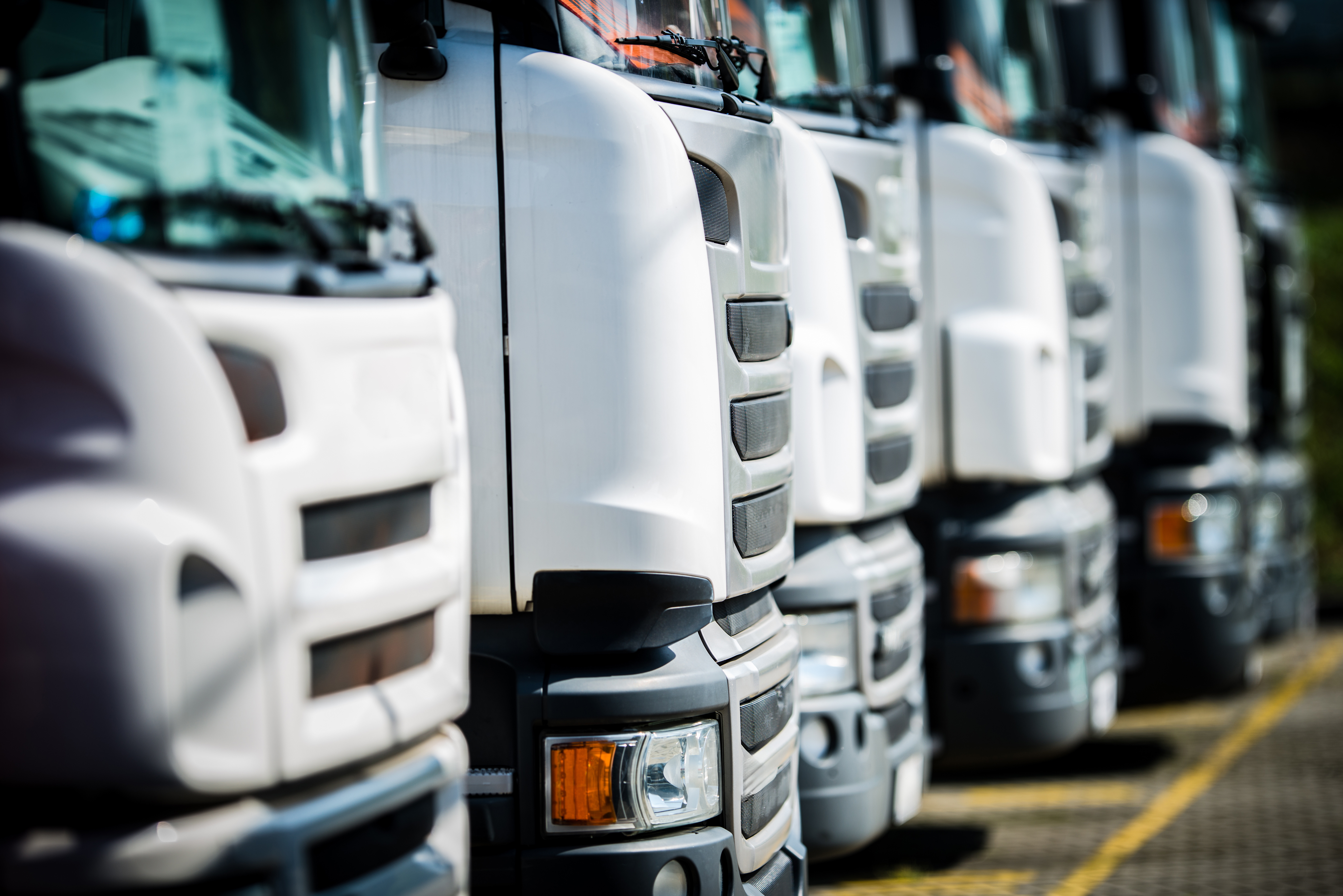 Line of UK haulage vehicles parked in a fleet yard